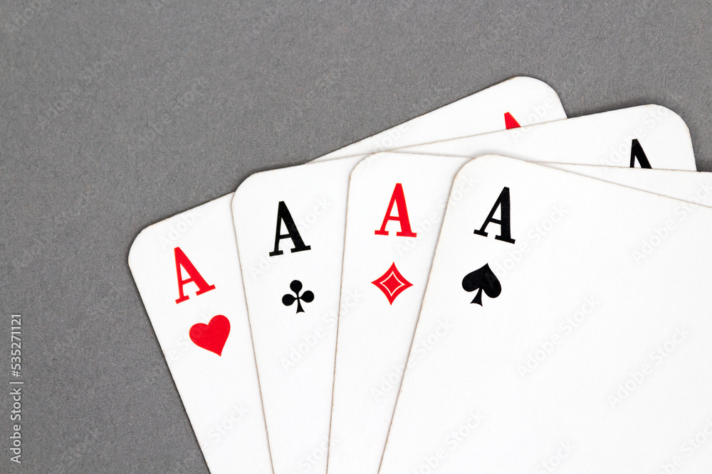 All four aces isolated on a gray background All four aces isolated on a gray background