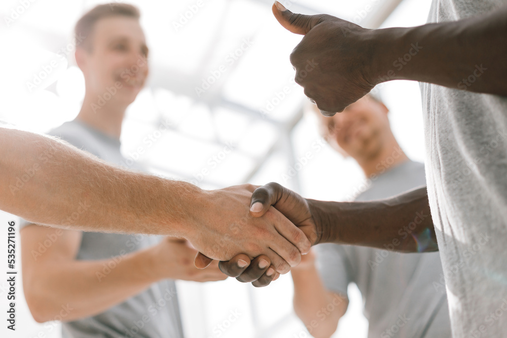 Fototapeta premium close up. two young like-minded people shaking hands.