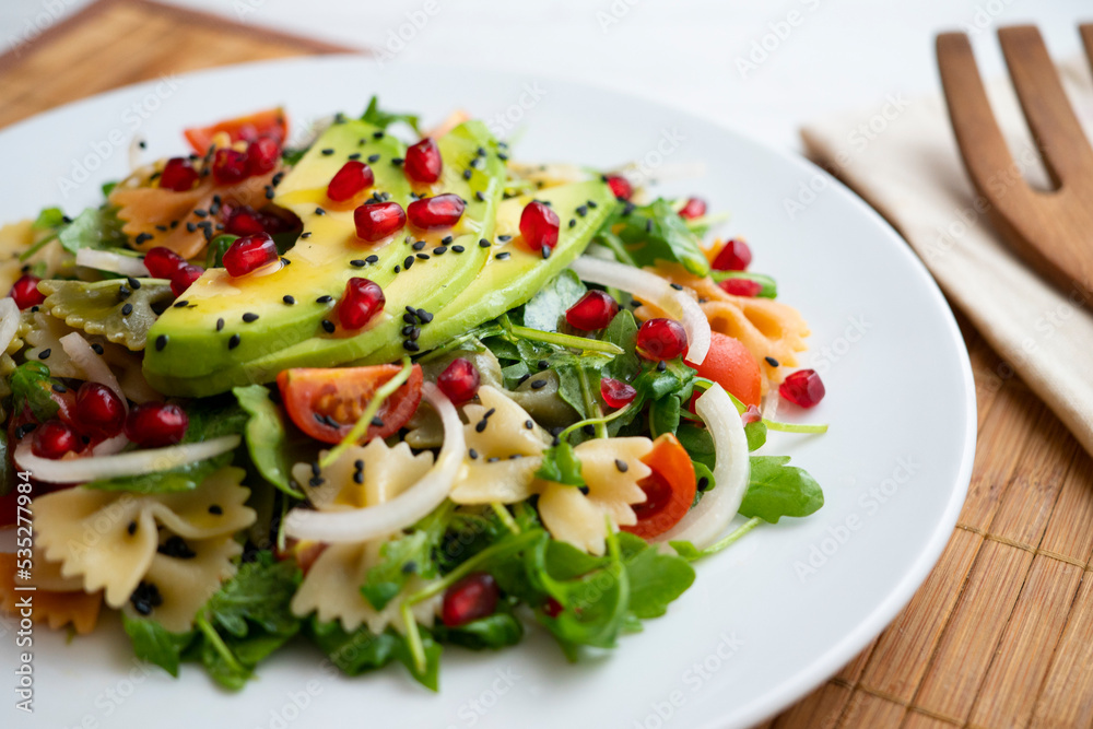 Argula salad with pasta bows, avocado, cherry tomatoes, pomegranate and sesame. Argula salad with pasta bows, avocado, cherry tomatoes, pomegranate and sesame.
