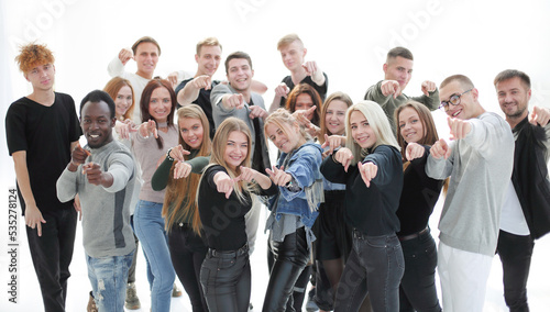 group of happy young people pointing at you.
