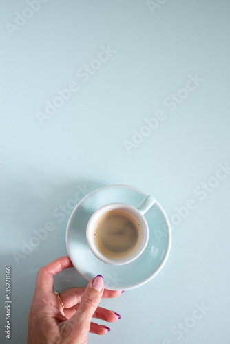 coffee in a light blue mini cup on a light blue background