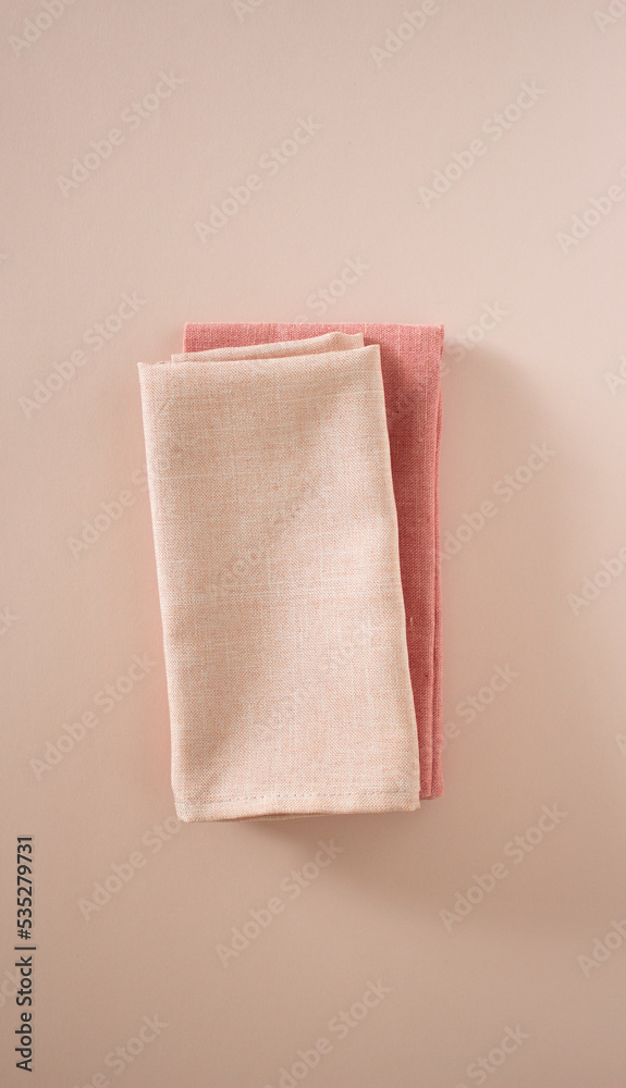 two pink towels on a pink background