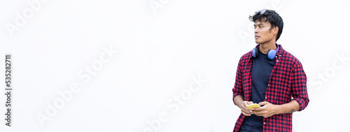 Horizontal banner or header with isolated young asiatic man using mobile smart phone on a white background - Generation z and millennial people always connected