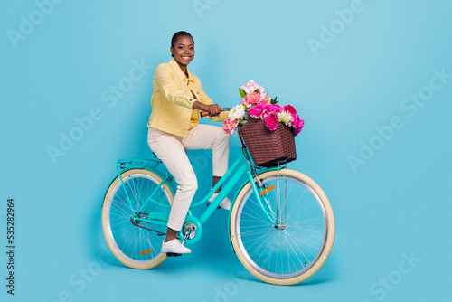 Full length body size view of attractive cheerful girl riding bike free time isolated over bright blue color background