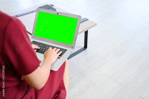 Manager woman working at mockup green screen chroma key laptop with isolated display. businesswoman sitting and working with laptop computer.