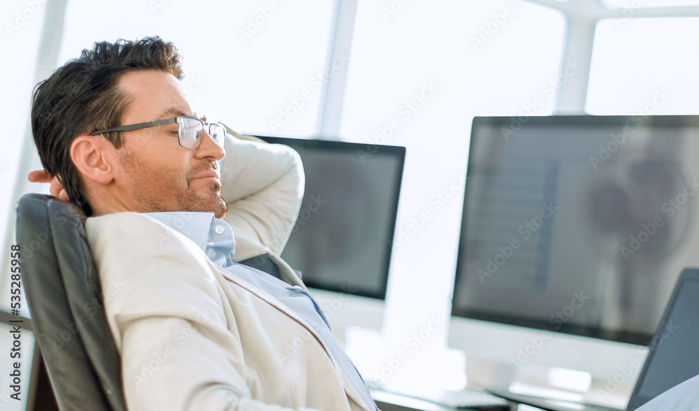 businessman sitting at his Desk during a working break businessman sitting at his Desk during a working break