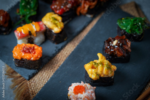 Sushi is a Japanese dish of prepared vinegared rice (鮨飯, sushi-meshi), usually with some sugar and salt, accompanied by a variety of ingredients