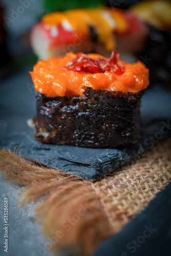 Sushi is a Japanese dish of prepared vinegared rice (鮨飯, sushi-meshi), usually with some sugar and salt, accompanied by a variety of ingredients