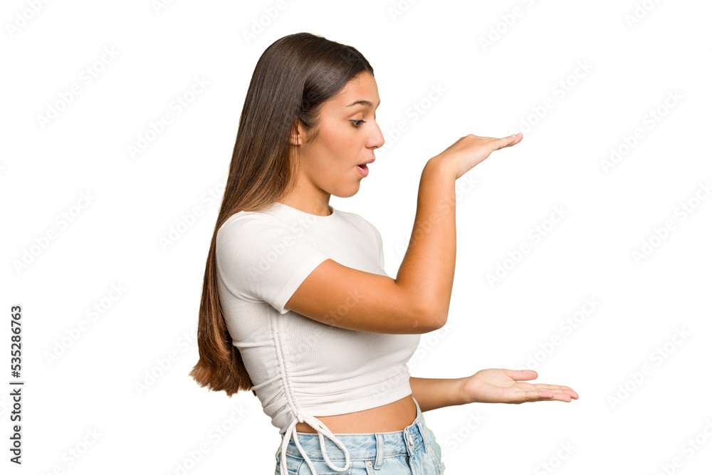 Young Indian woman isolated cutout removal background shocked and amazed holding a copy space between hands. Young Indian woman isolated cutout removal background shocked and amazed holding a copy space between hands.