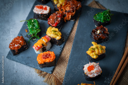 Sushi is a Japanese dish of prepared vinegared rice (鮨飯, sushi-meshi), usually with some sugar and salt, accompanied by a variety of ingredients