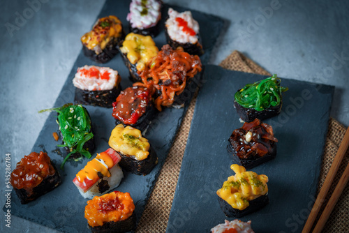 Sushi is a Japanese dish of prepared vinegared rice (鮨飯, sushi-meshi), usually with some sugar and salt, accompanied by a variety of ingredients