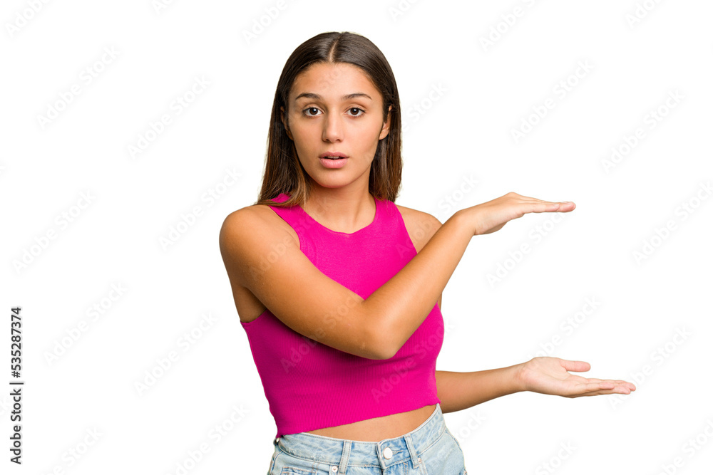 Young Indian woman isolated cutout removal background shocked and amazed holding a copy space between hands. Young Indian woman isolated cutout removal background shocked and amazed holding a copy space between hands.