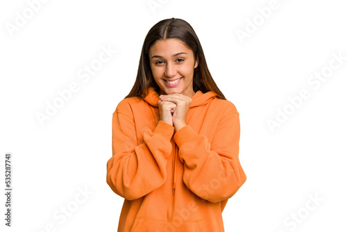 Young Indian woman isolated cutout removal background keeps hands under chin, is looking happily aside.