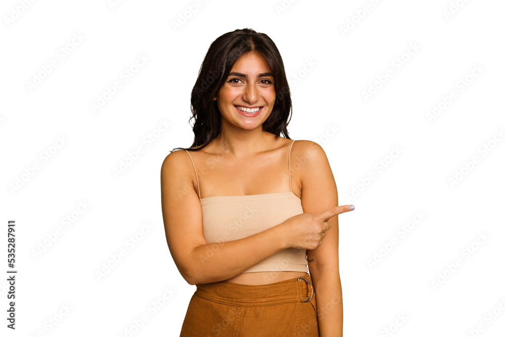 Young Indian woman isolated on green chroma background smiling and pointing aside, showing something at blank space.