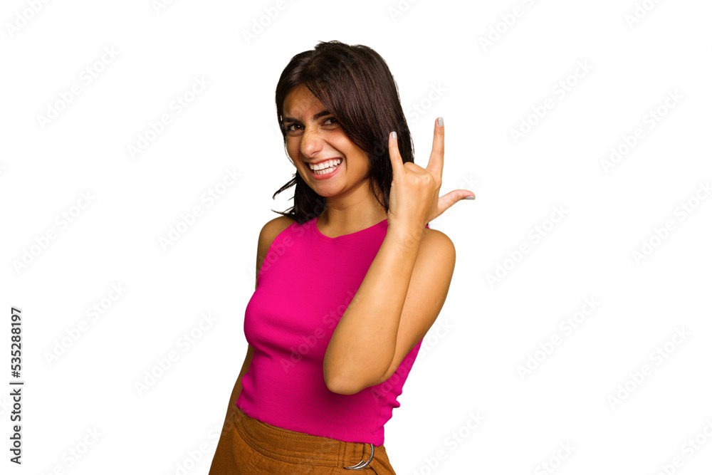 Young Indian woman isolated on green chroma background showing rock gesture with fingers Young Indian woman isolated on green chroma background showing rock gesture with fingers