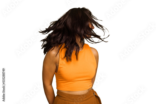 Young Indian woman isolated on green chroma background dancing and having fun.