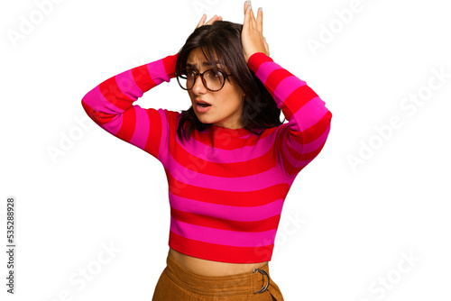 Young Indian woman isolated on green chroma background screaming, very excited, passionate, satisfied with something.