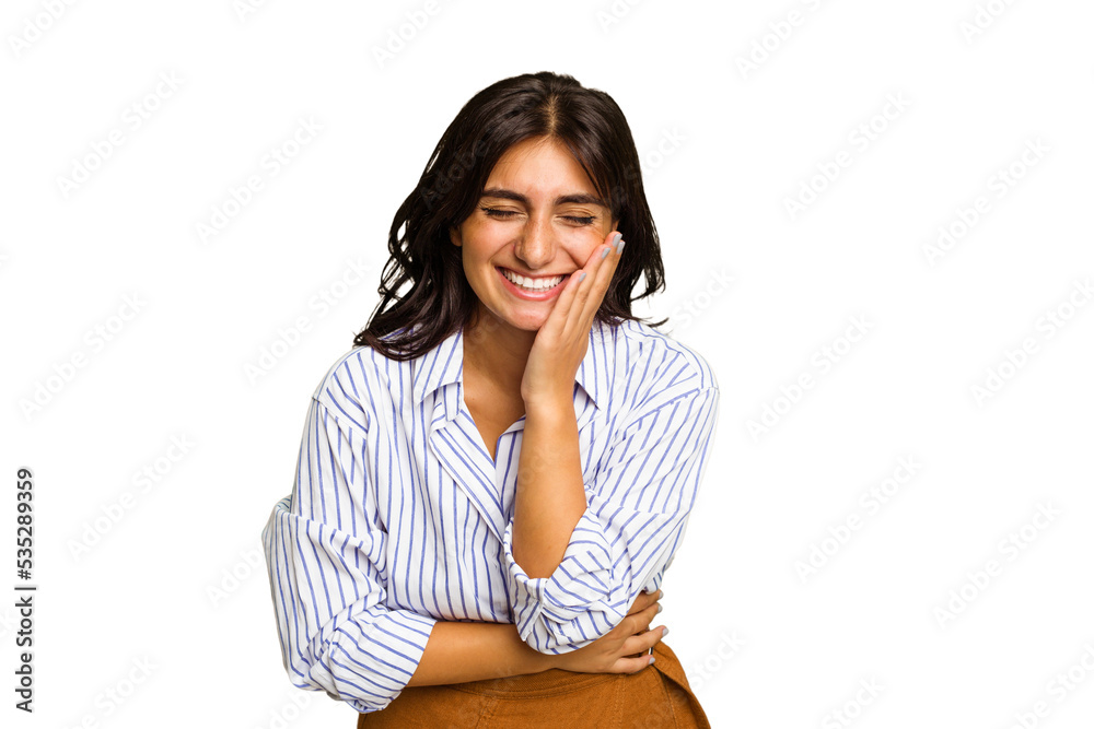 Young Indian woman isolated on green chroma background laughs happily and has fun keeping hands on stomach. Young Indian woman isolated on green chroma background laughs happily and has fun keeping hands on stomach.