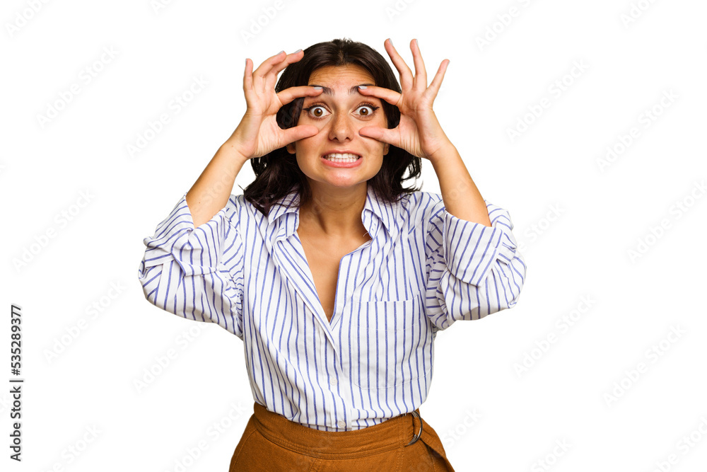 Young Indian woman isolated on green chroma background keeping eyes opened to find a success opportunity. Young Indian woman isolated on green chroma background keeping eyes opened to find a success opportunity.