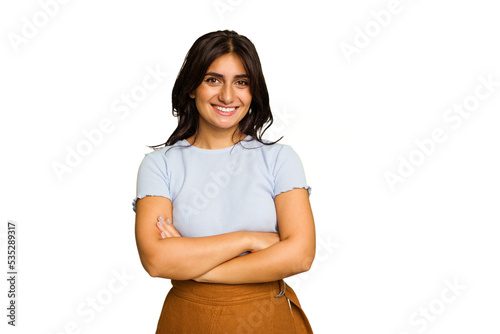 Young Indian woman isolated on green chroma background who feels confident, crossing arms with determination.