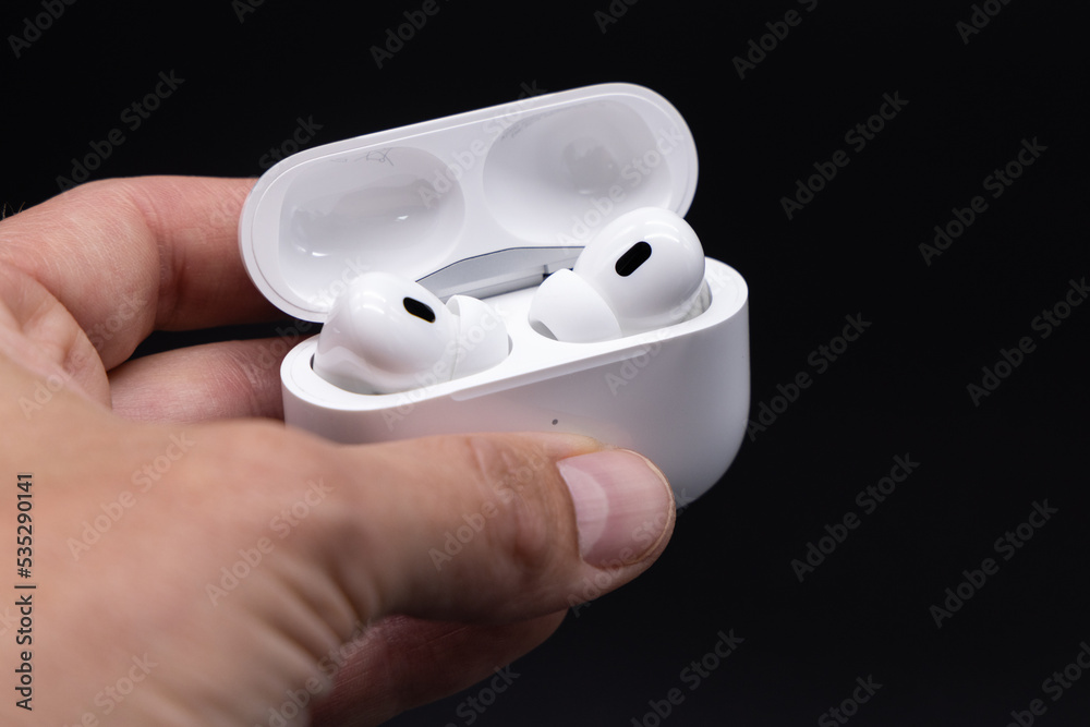 Apple AirPods Pro 2nd generation inside charging case held by a hand,  October 2, 2022, Germany Stock Photo | Adobe Stock