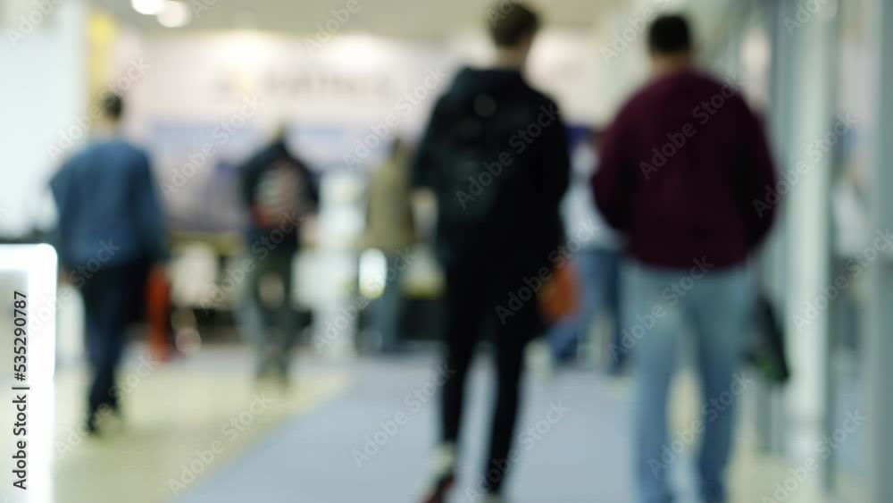 Timelapse of the movement of a crowd of business people walking through a large, bright business center hall. Timelapse of the movement of a crowd of business people walking through a large, bright business center hall.