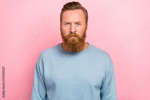 Portrait photo of young bearded redhair handsome man unhappy angry agressive conflict man isolated on pink color background photo
