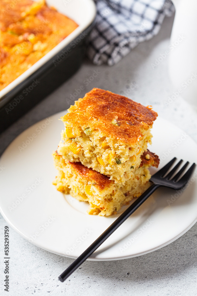 Portion of Christmas cheddar cornbread on white plate, close-up. Festive recipe food concept. Portion of Christmas cheddar cornbread on white plate, close-up. Festive recipe food concept.