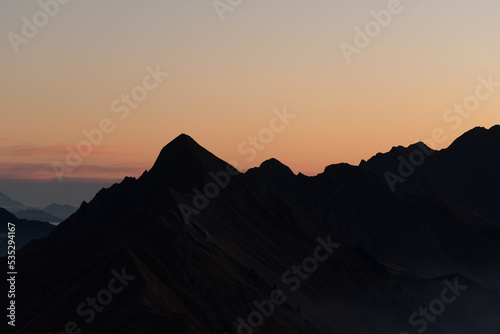Sunrise with colorful sky and a mountain silhouette in switzerland