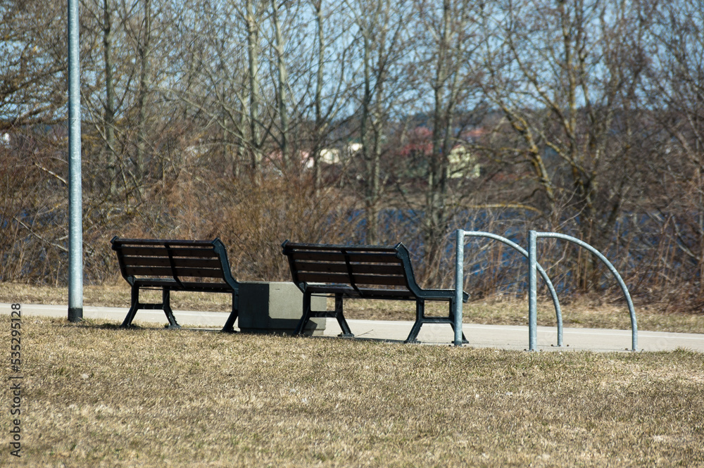 benches in the recreation park in the background the river and the blue sky benches in the recreation park in the background the river and the blue sky