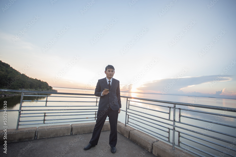 Man with her old suit at ubonrat dam,Thailand Man with her old suit at ubonrat dam,Thailand