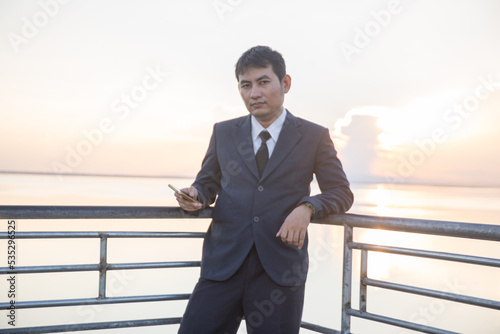 Man with her old suit at ubonrat dam,Thailand photo