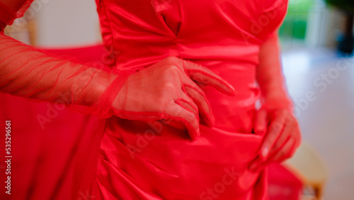 woman in red dress with hands on hips