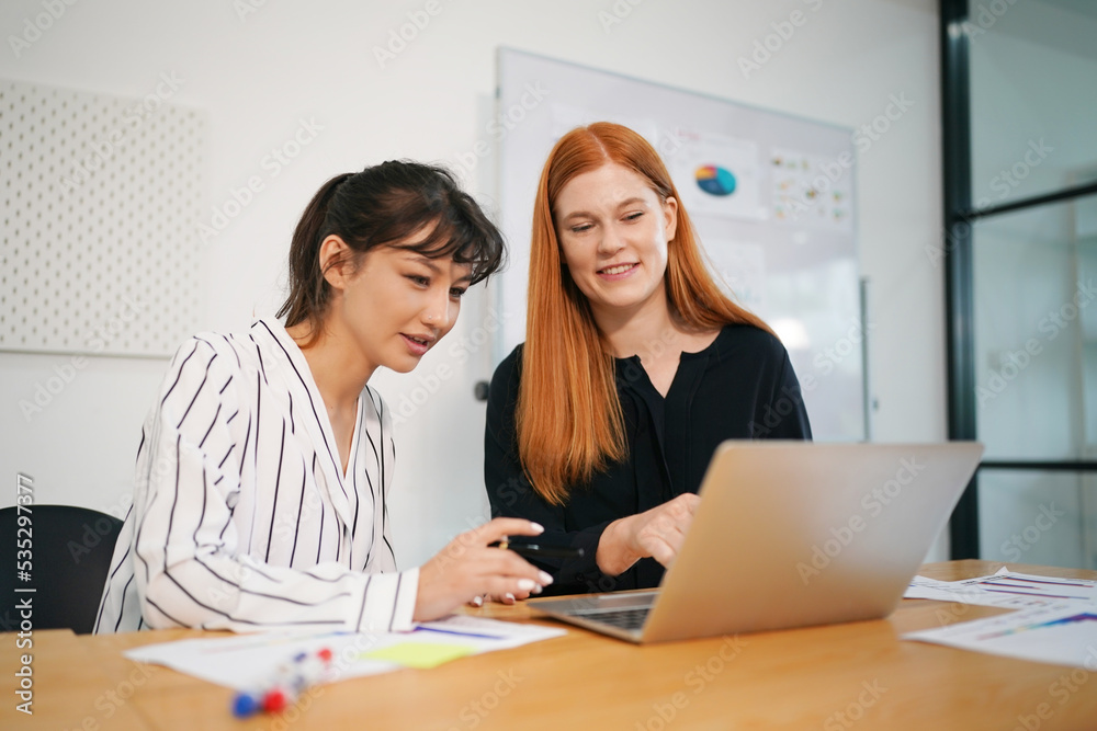 Two business people working together on laptop. Two business people working together on laptop.