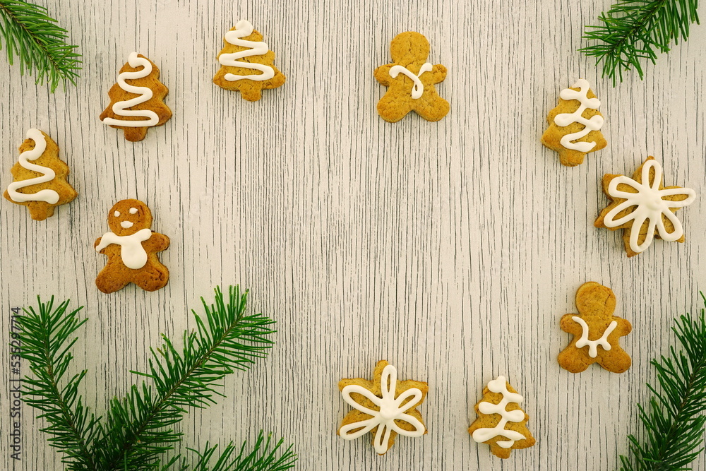 New Year composition with of fresh baked homemade cookies and fir branches. Christmas background with gingerbread. Top view, copy space, flat lay. New Year composition with of fresh baked homemade cookies and fir branches. Christmas background with gingerbread. Top view, copy space, flat lay.