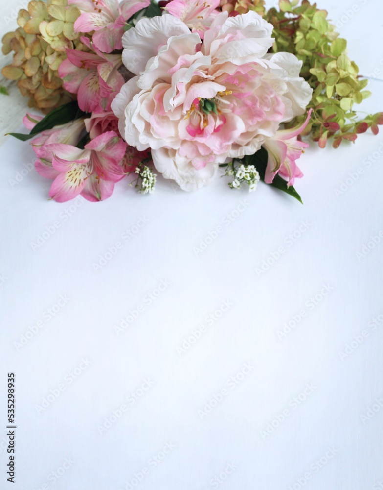 Bouquet of pink roses, peonies and alstroemeria on a white background. Festive flower arrangement. Background for a greeting card.