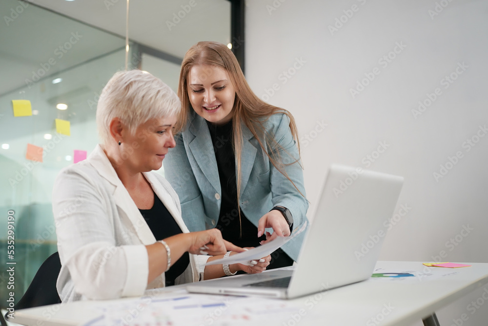 Two business people working together on laptop. Two business people working together on laptop.