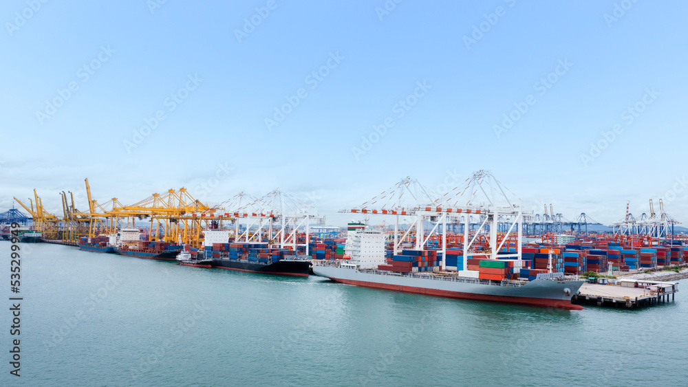 Fototapeta premium Container ship loading and unloading in commercial port, business service of goods logistic import and export freight transportation by container ship in sea,