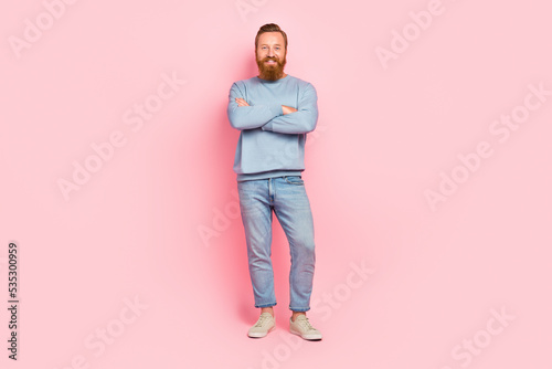 Full size portrait of satisfied glad young man crossed arms toothy smile isolated on pink color background