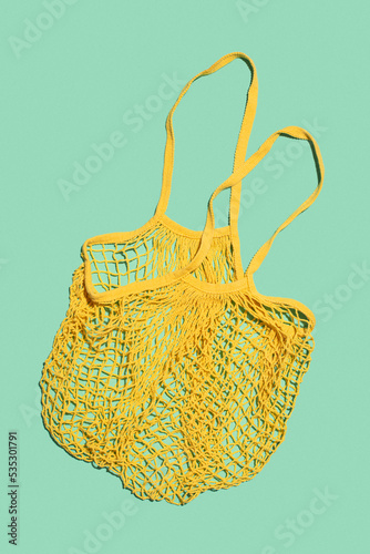 Yellow shopping bag on a salad background. Eco friendly.