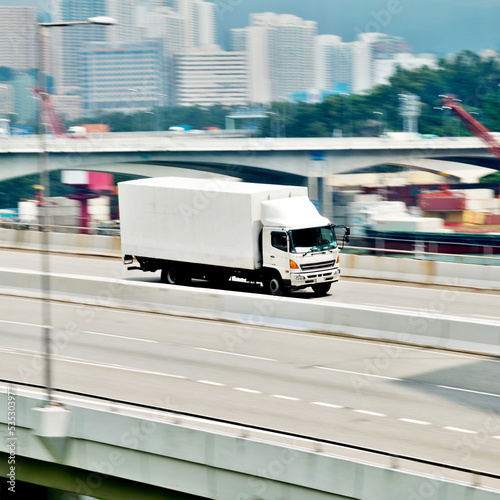 Container truck motion blur on highway overpass