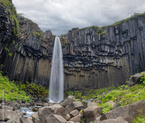 Svartifoss (black) waterfall in the Vatnajökull National Park, Southern Iceland. It is surrounded by dark basalt lava columns,