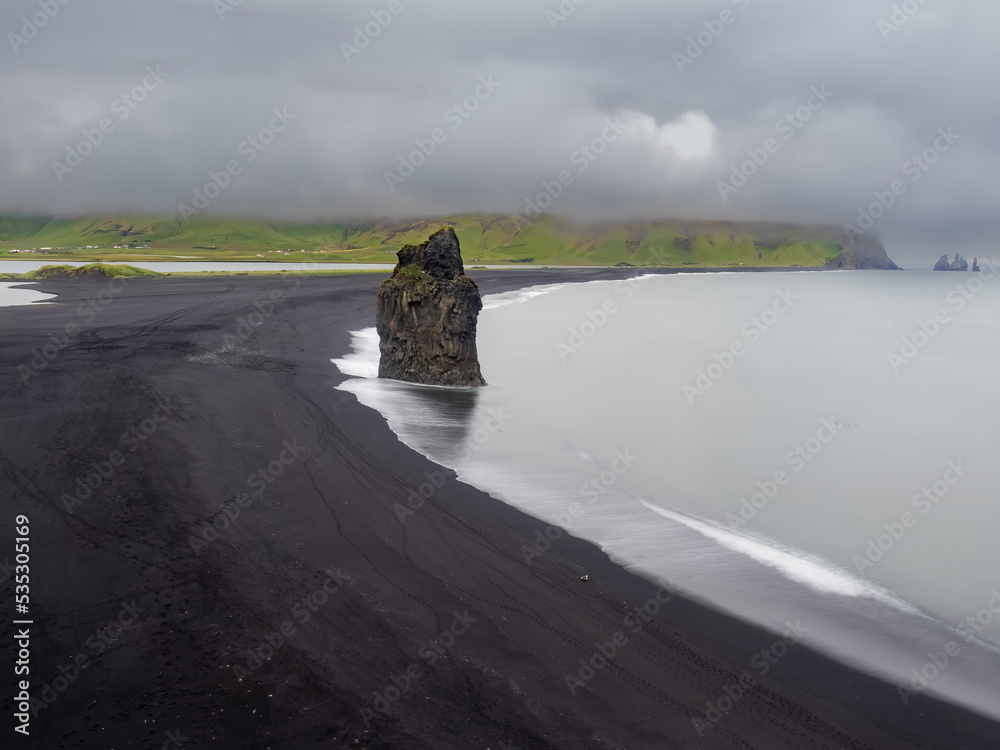The iconic black sand beaches of Reynisfjara and the sea stacks ...
