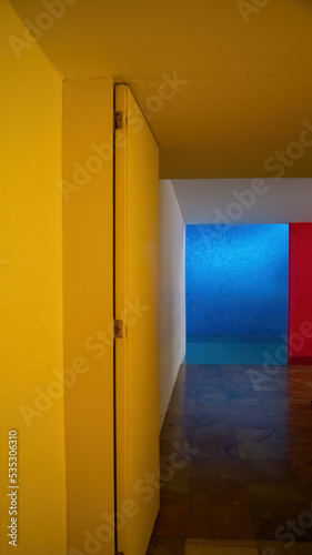 interior of the gilardi house of the famous architect luis barragan, pool reflecting the light, blue wall and red column, mexico photo