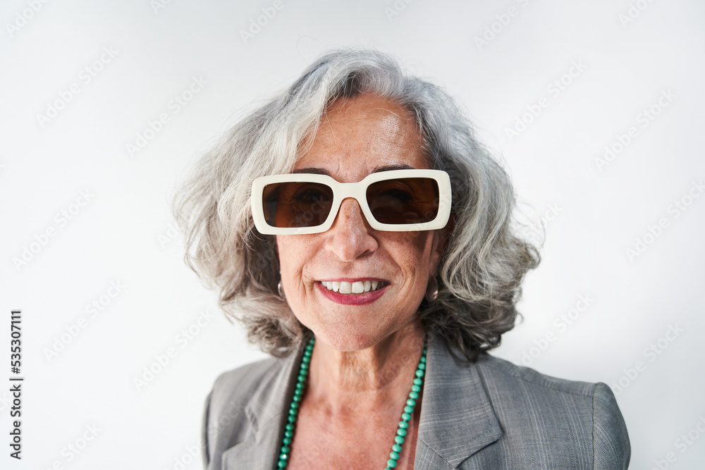 Cheerful aged woman in stylish sunglasses Cheerful aged woman in stylish sunglasses