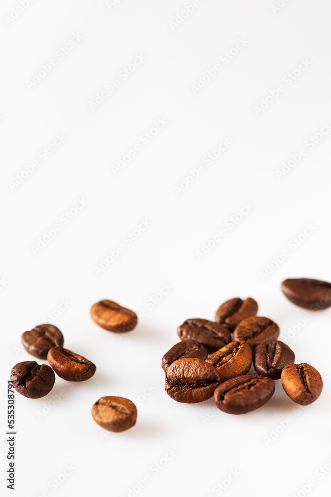 Fototapeta premium Scattered roasted coffee beans on white isolated background