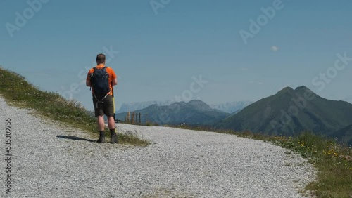 Drone camera quadcopter operator flying and landing air technology device on the top of the mountain. Outdoor traveler man filming nature and hiking activity. Beautiful landscape of Alps mountains. (ID: 535309755)