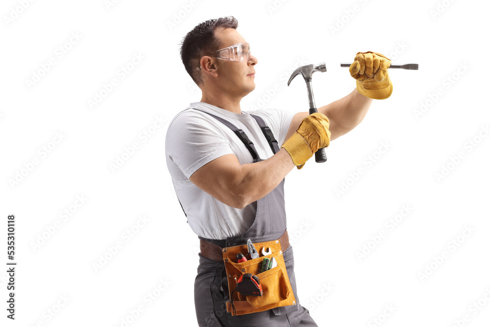 Repairman in a uniform working with a hammer Repairman in a uniform working with a hammer