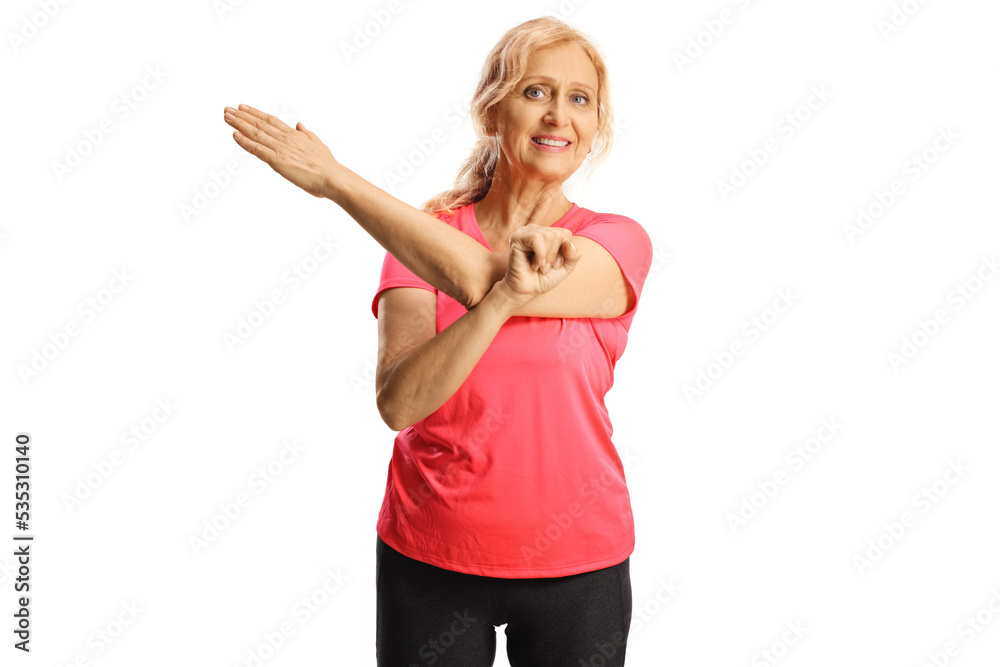 Fototapeta premium Mature woman in sportswear stretching an arm