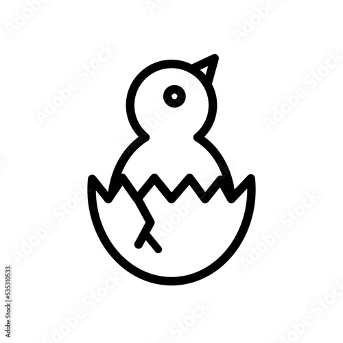 A chicken that is hatching from an egg